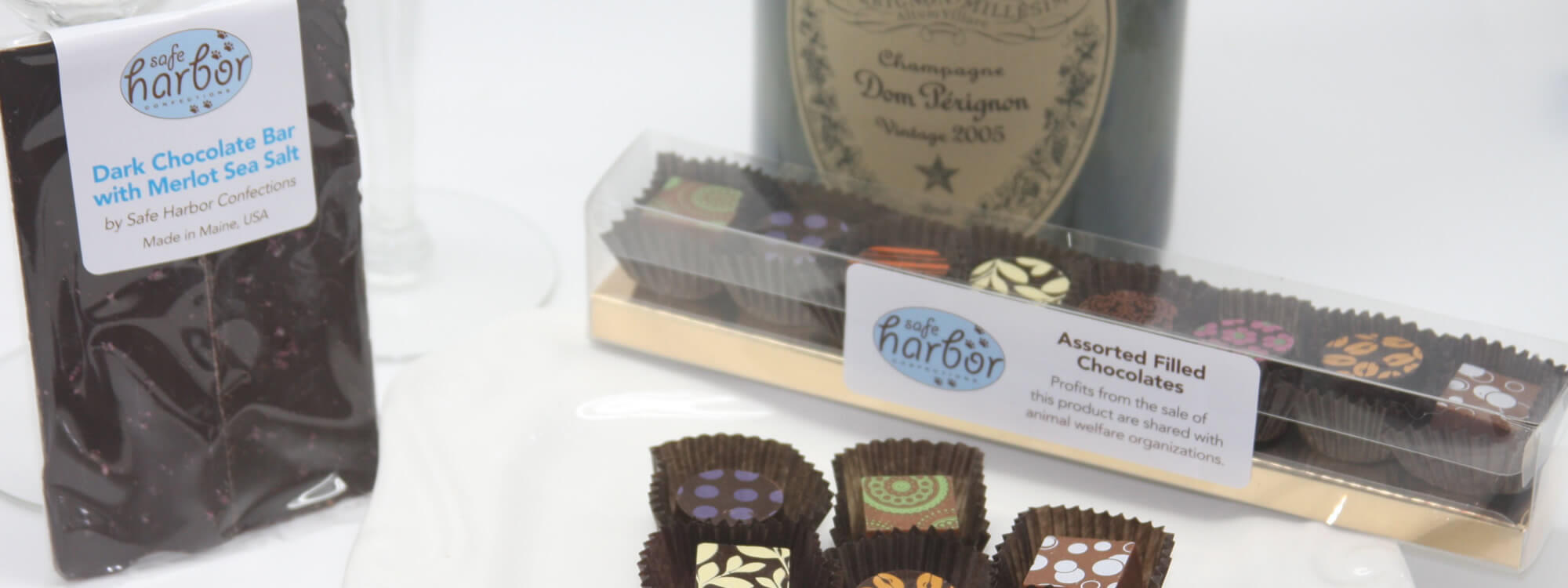 Banner featuring assorted filled chocolates and dark chocolate with merlot sea salt created by Safe Harbor Confections.